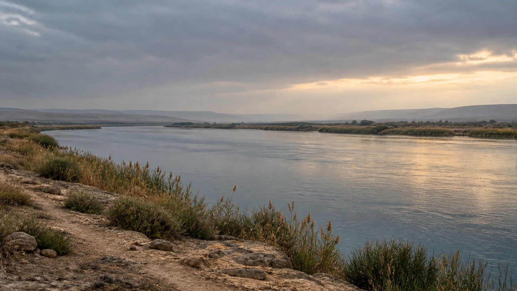A broad river crossing a quiet, timeworn landscape