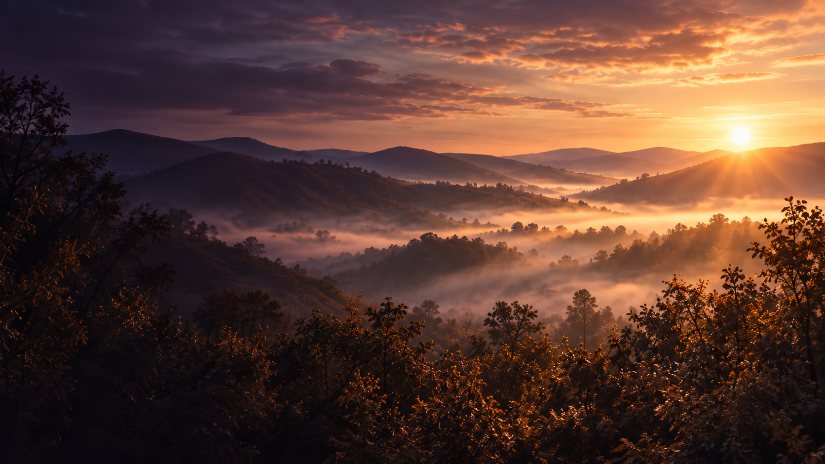 Warm first light over misty hills